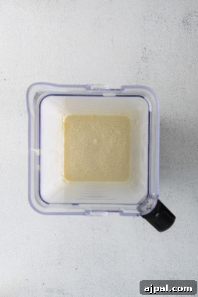 A blender filled with smooth, yellow crepe batter, perfectly mixed.