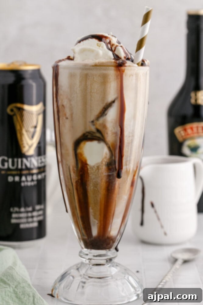 Guinness Baileys Float Delight 2 Guinness float in a glass with a gold paper straw and chocolate syrup
