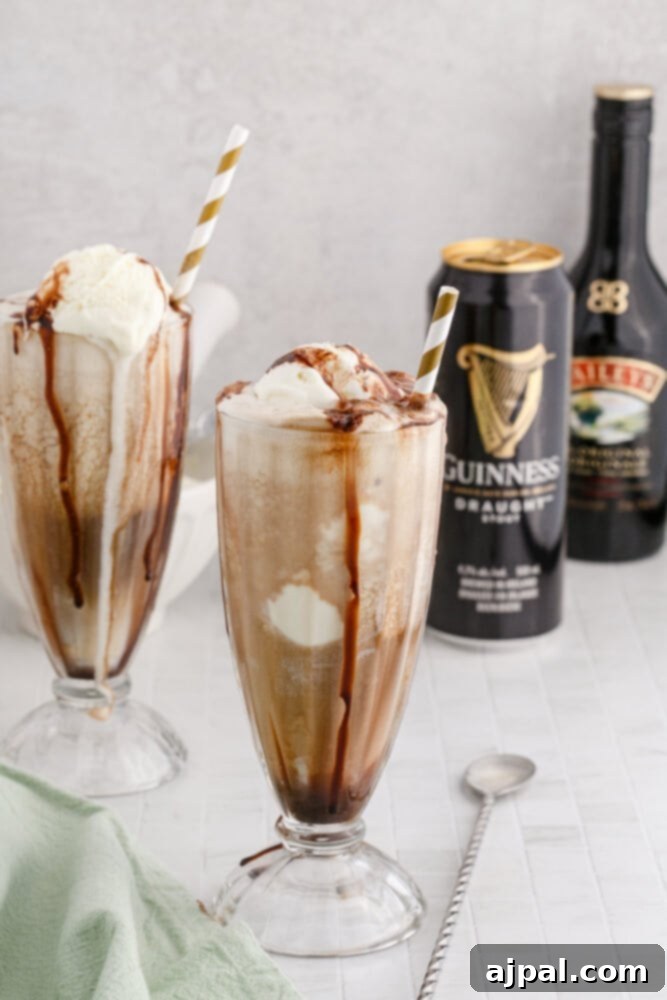 Guinness Baileys Float Delight 3 Guinness float in a glass with a gold paper straw and chocolate syrup