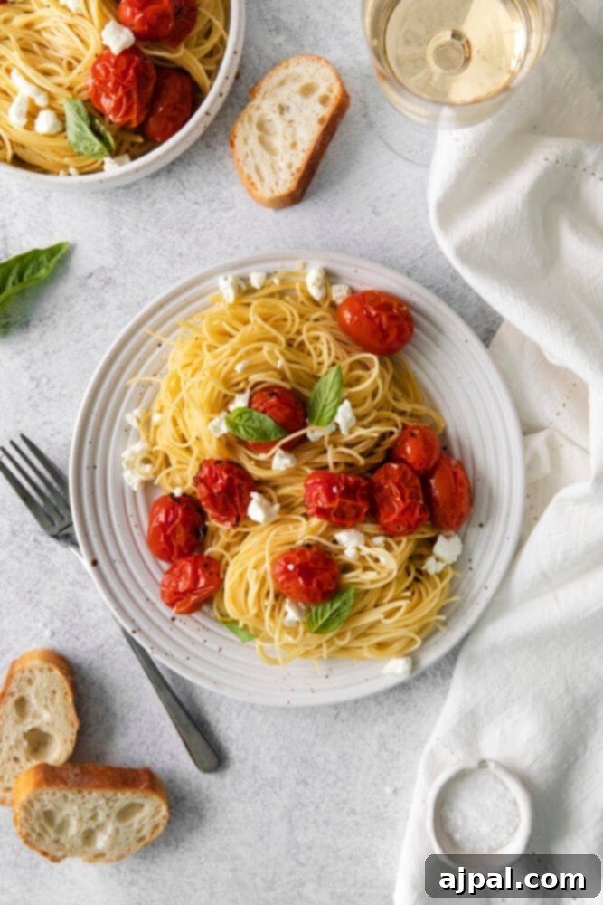 Creamy Goat Cheese and Roasted Tomato Pasta 3 Goat cheese, tomatoes, and pasta combine to create a flavorful and inviting dish, presented on a pristine white plate.