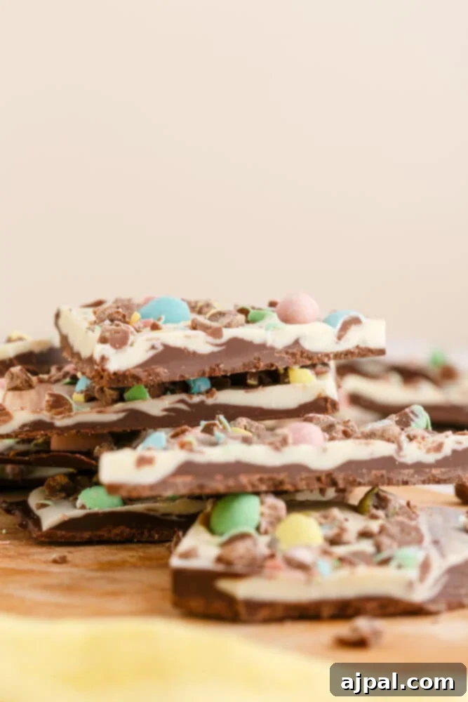 stack of white and dark chocolate bark with m&ms in it