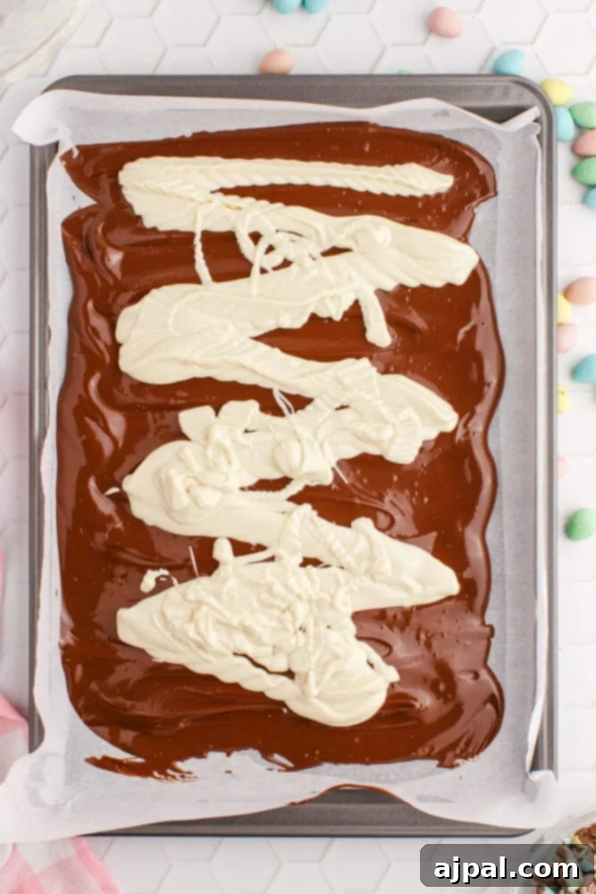 milk chocolate in a 9x13 casserole dish with white chocolate on it.