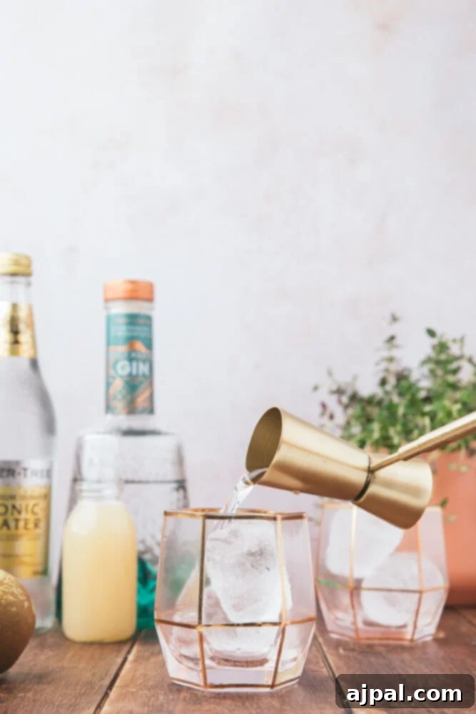 Golden Pear Fizz 6 picture of a cocktail measurer pouring gin