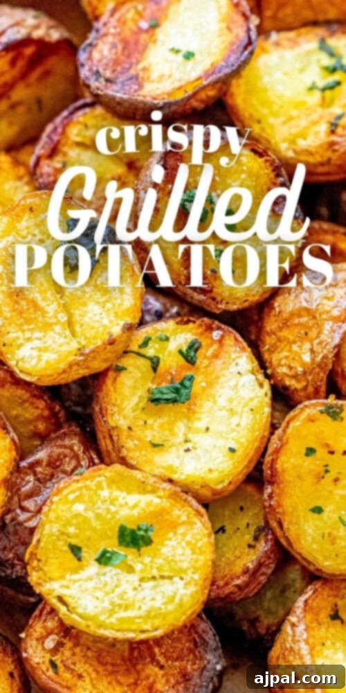 A vertical shot of crispy grilled potatoes in a wooden bowl, garnished with herbs and a sprinkle of salt.