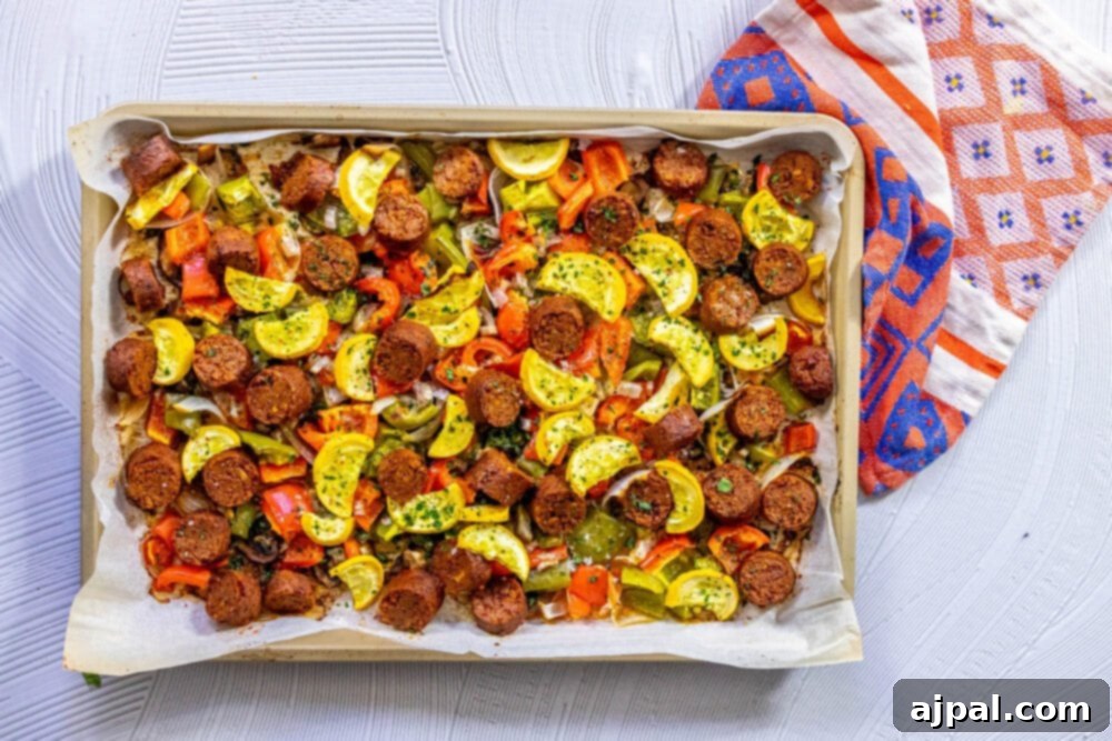One-Pan Vegan Chorizo Veggie Bake 11 picture of baked vegan chorizo sausage, squash, peppers, onions, and mushrooms on a baking sheet