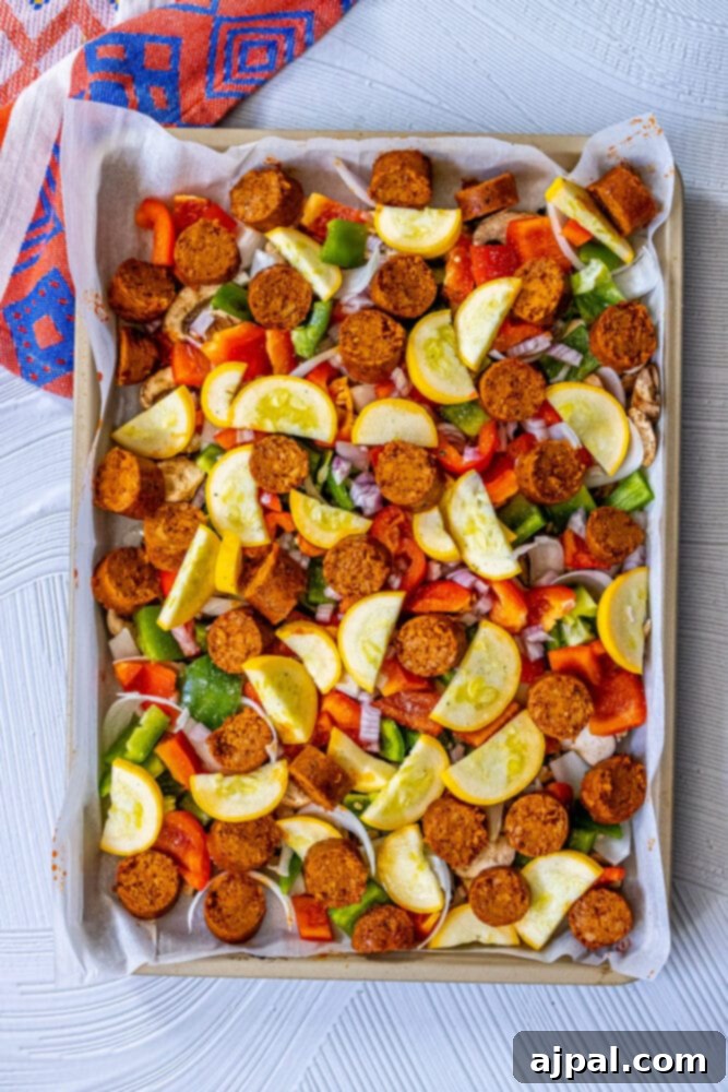 One-Pan Vegan Chorizo Veggie Bake 7 picture of seasoned sliced vegan chorizo, green onions, onion, shallot, bell peppers, mushrooms on a baking sheet