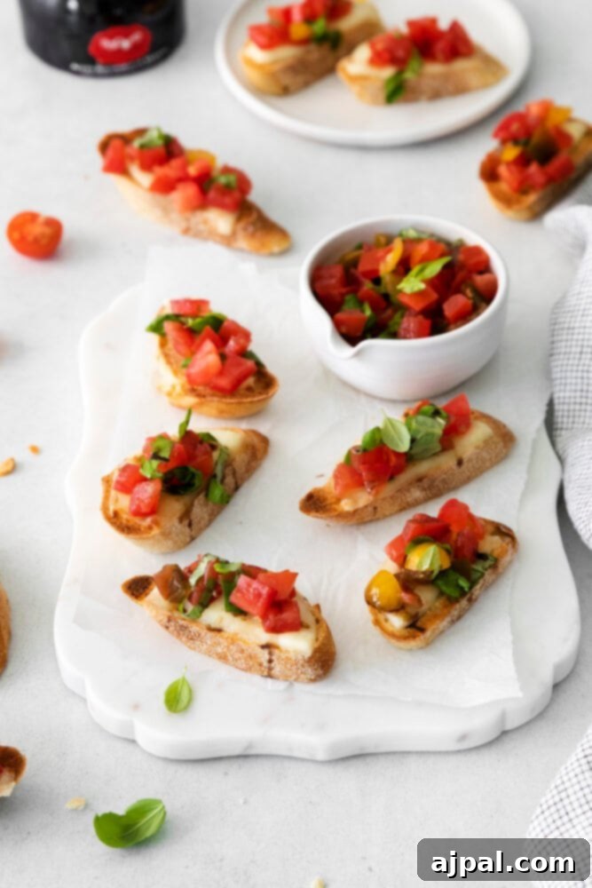 Fresh Caprese Bruschetta 3 Freshly prepared Caprese Bruschetta with vibrant tomatoes and basil on a white plate, ready to be enjoyed.