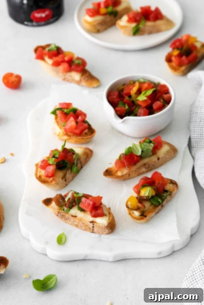 Vibrant Caprese Toasts 3 A beautifully presented plate of Caprese Bruschetta, highlighting the fresh red tomatoes and vibrant green basil on a white plate.