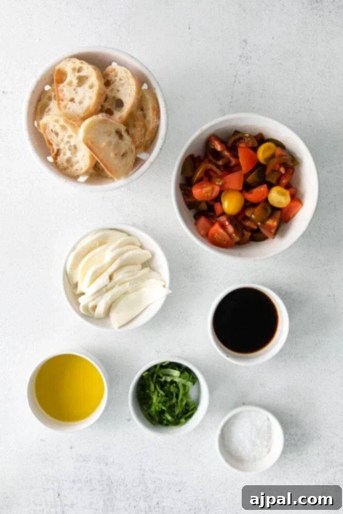Vibrant Caprese Toasts 4 Ingredients for Caprese Bruschetta laid out on a table, including bread, tomatoes, cheese, olive oil, balsamic dressing, salt, and basil in separate bowls.