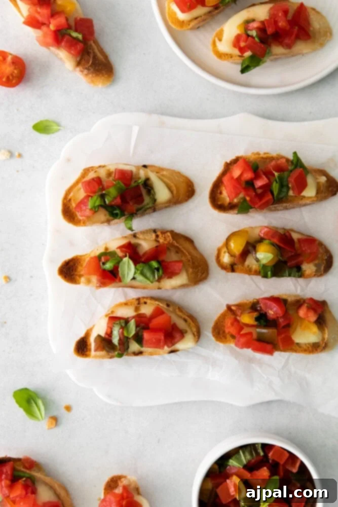 Vibrant Caprese Toasts 7 An individual serving of Caprese Bruschetta on a white plate, beautifully garnished with fresh basil leaves.