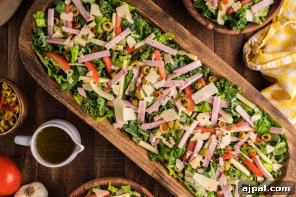 A beautifully arranged Julienne Kale Salad with ham and Mediterranean dressing, served on a rustic wooden board, ready to be enjoyed.
