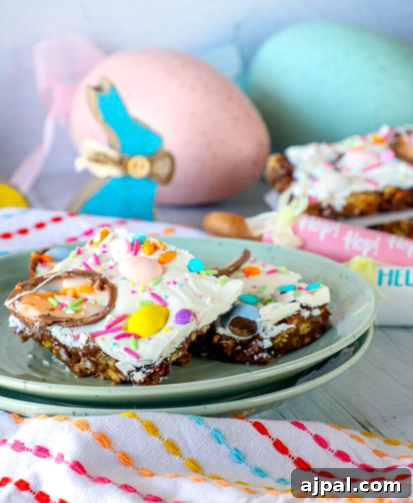 Rocky Road Bars: Cadbury Creme Egg Edition 2 A vibrant plate of Cadbury Creme Egg Rocky Road Bars, showcasing halved Cadbury Creme Eggs, mini eggs, and colorful sprinkles atop a rich chocolate base.