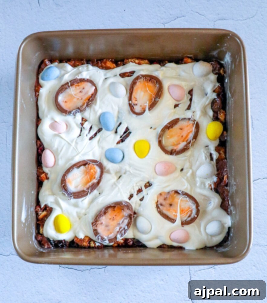 Rocky Road Bars: Cadbury Creme Egg Edition 11 A baking pan filled with finished Easter brownies, lavishly topped with Cadbury Creme Egg Rocky Road elements and colorful candy decorations.