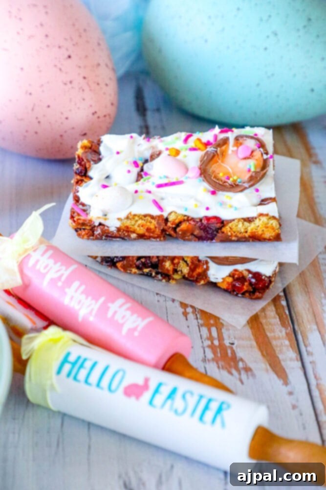 Rocky Road Bars: Cadbury Creme Egg Edition 3 Close-up of festive Easter cookie bars adorned with colorful sprinkles and whole Cadbury Creme Eggs on a table.