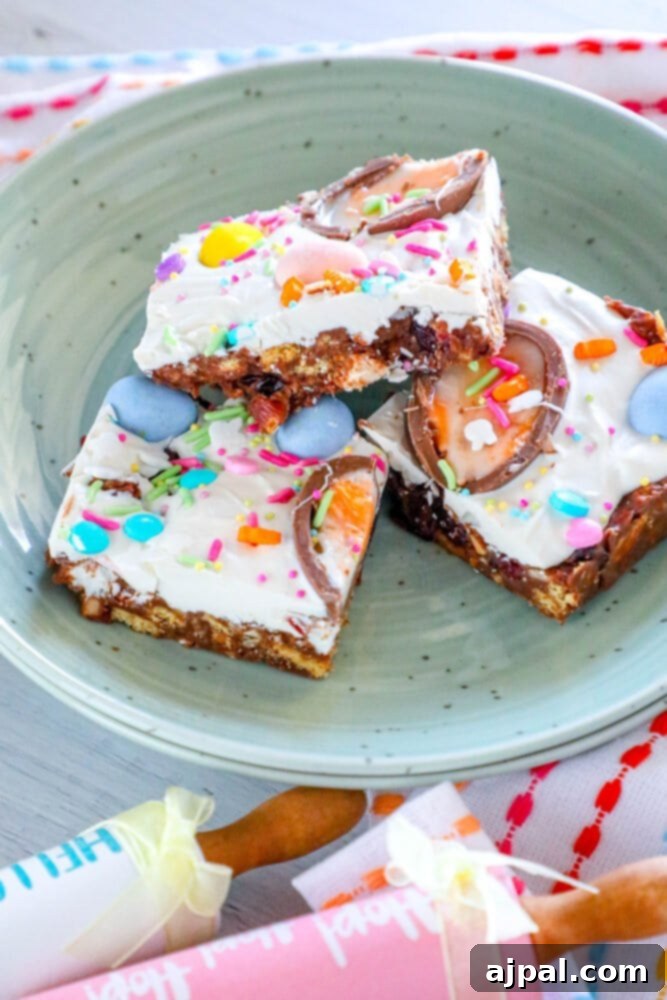 Rocky Road Bars: Cadbury Creme Egg Edition 15 A festive plate of Easter candy chocolate bark, adorned with colorful sprinkles and various Easter-themed sweets.