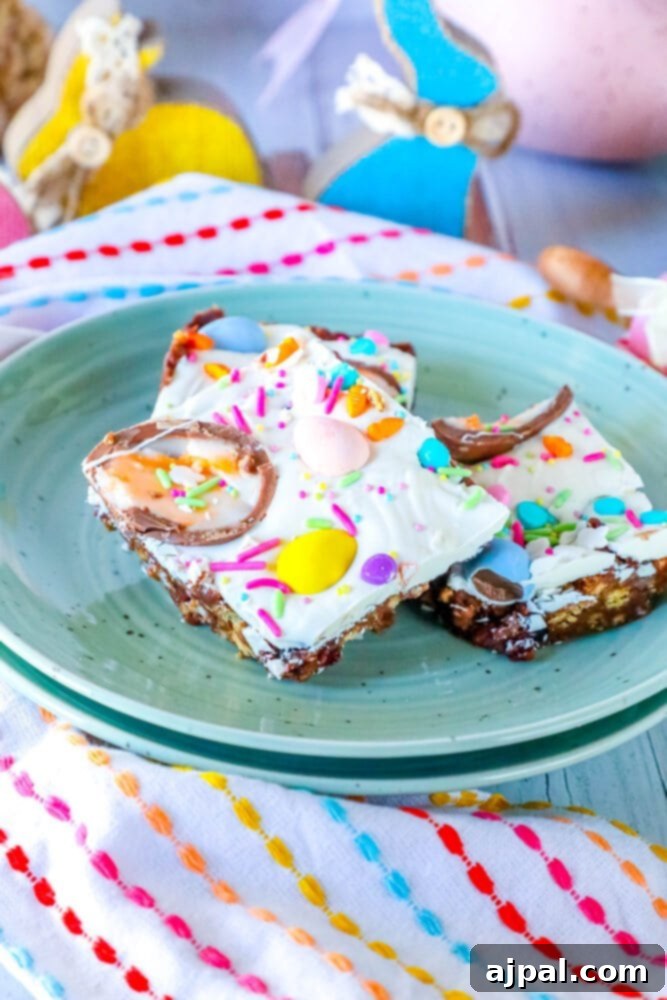 Rocky Road Bars: Cadbury Creme Egg Edition 4 Elegantly arranged Easter bars and halved Cadbury Creme Eggs presented on a decorative plate.