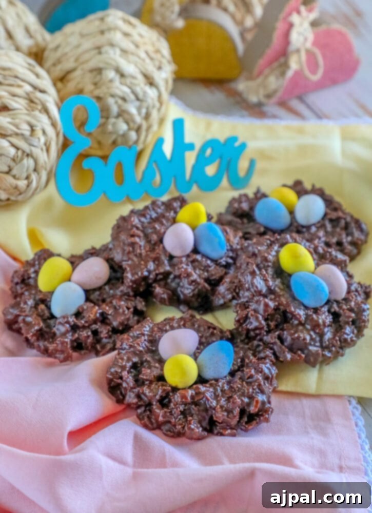 Easter Egg Nest Delights 3 Several chocolate Easter nest cookies with mini eggs on a patterned napkin, ready to be enjoyed.