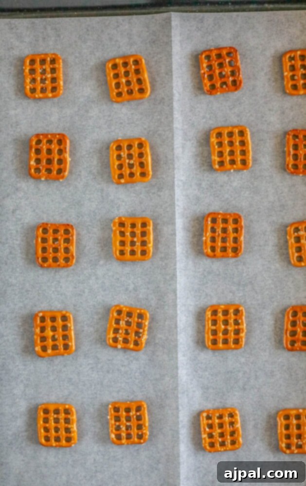 Hoppy Easter Pretzels 5 Pretzels arranged neatly on parchment paper, ready for chocolate.