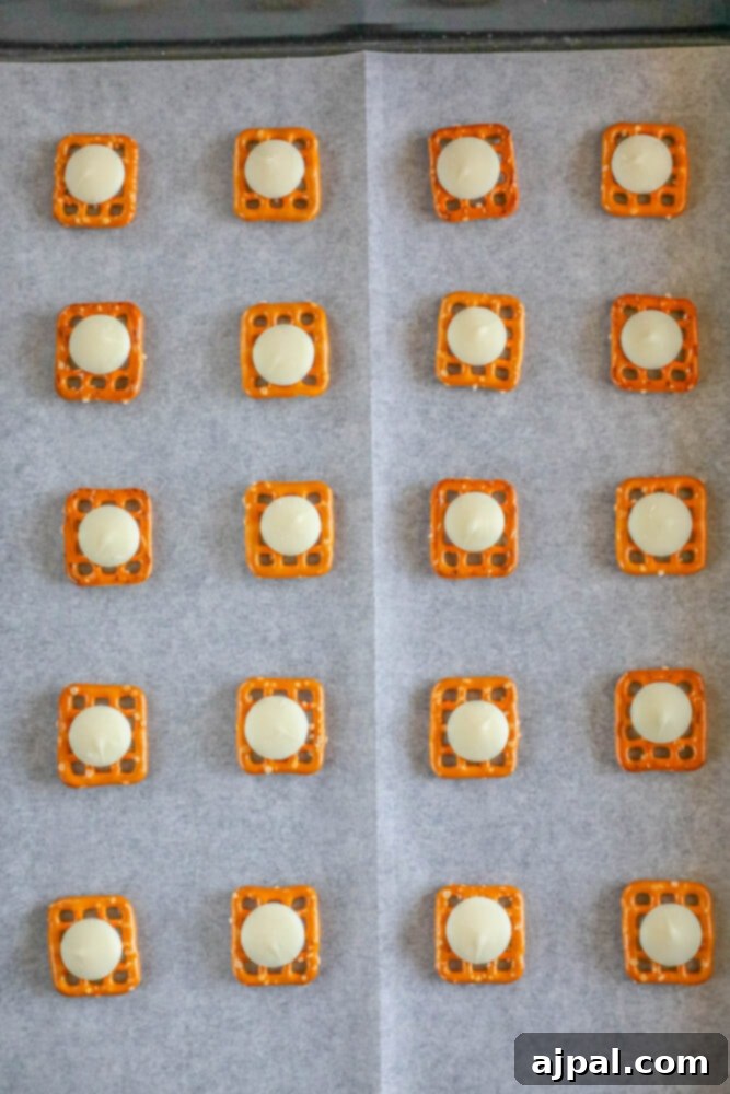 Hoppy Easter Pretzels 6 Pretzels on parchment paper, each topped with a candy wafer.