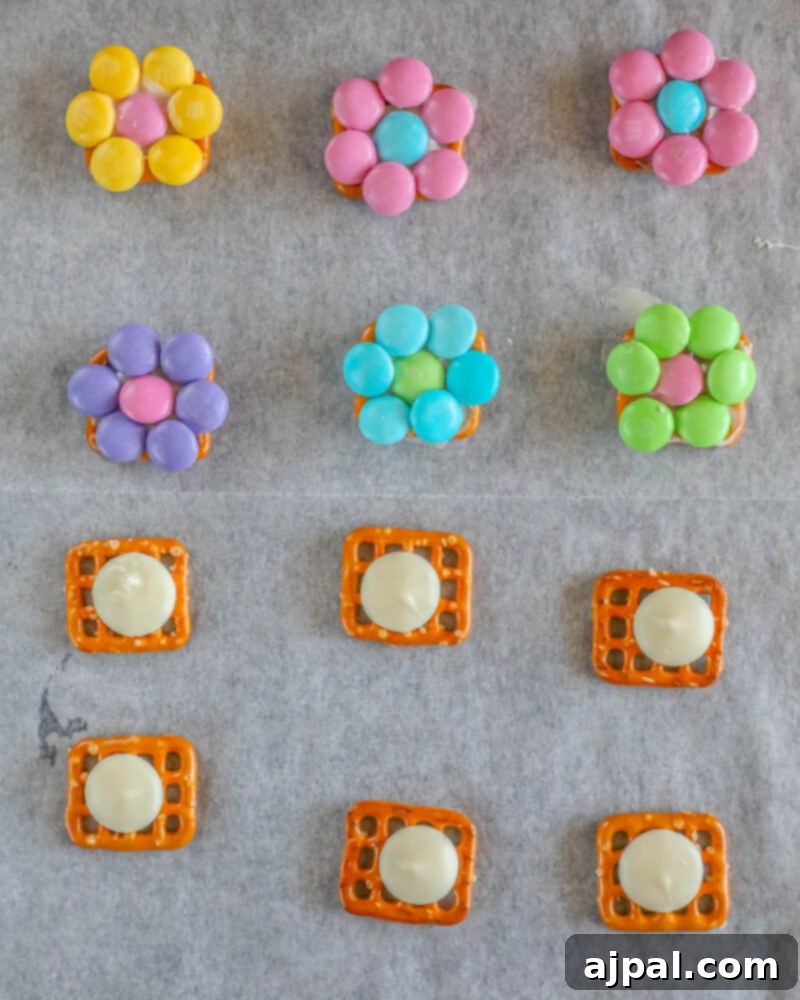 Hoppy Easter Pretzels 7 Easter pretzel candy in progress with M&Ms on a baking sheet lined with parchment paper.