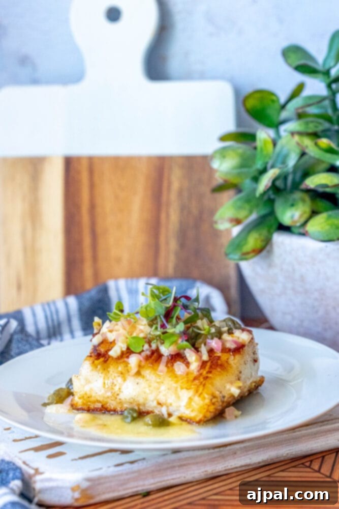 Pan-Seared Chilean Seabass with Lemon Caper Butter 3 A plate featuring a perfectly pan-seared piece of lemon caper seabass, ready to be enjoyed.