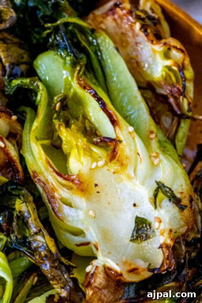 Grilled Sesame Ginger Bok Choy 3 A bowl of grilled bok choy generously sprinkled with sesame seeds, ready to be served.