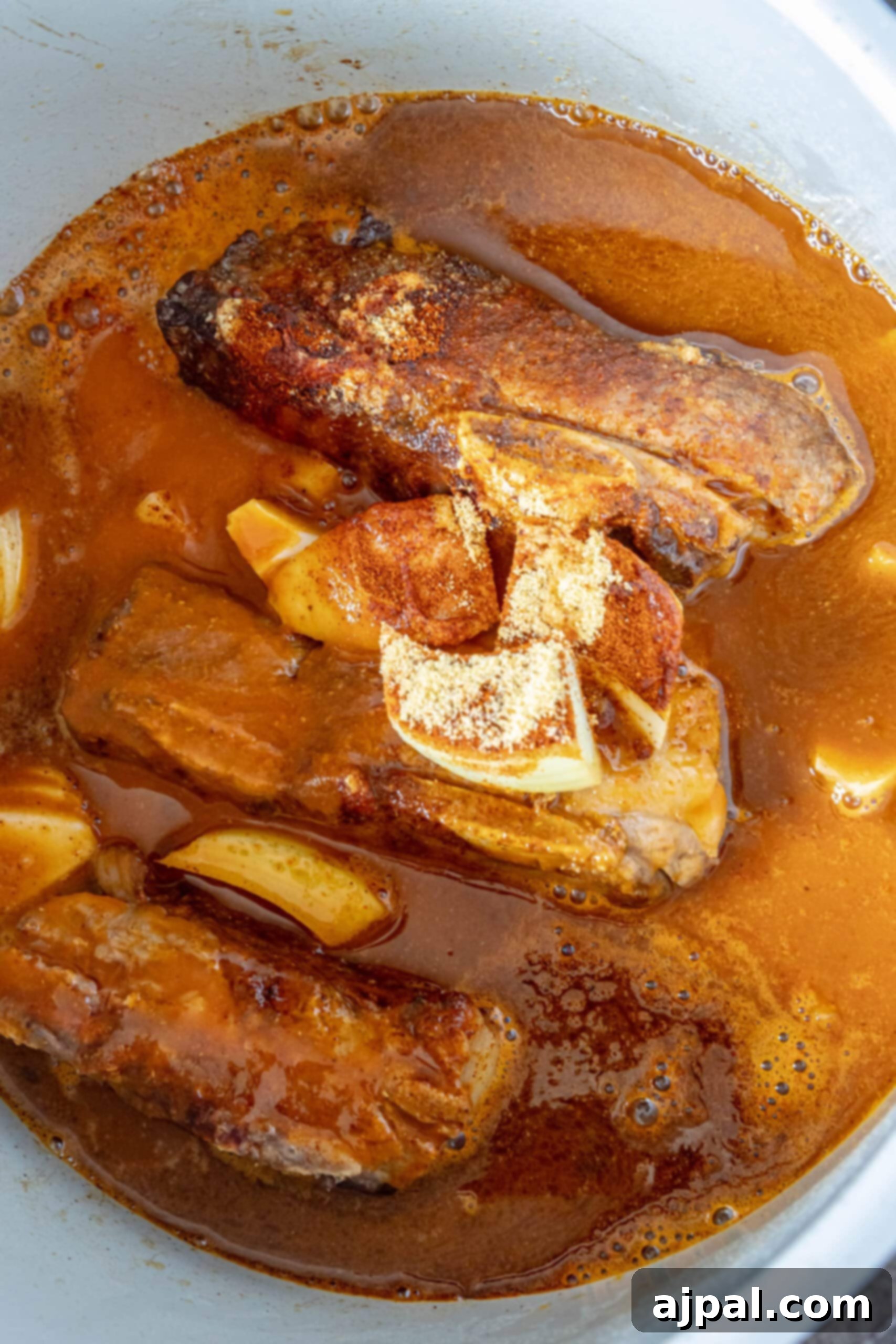 picture of short ribs in an instant pot with spices and beer