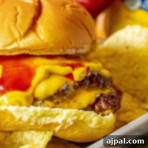 smashburger in a bun with mustard, cheese, and ketchup