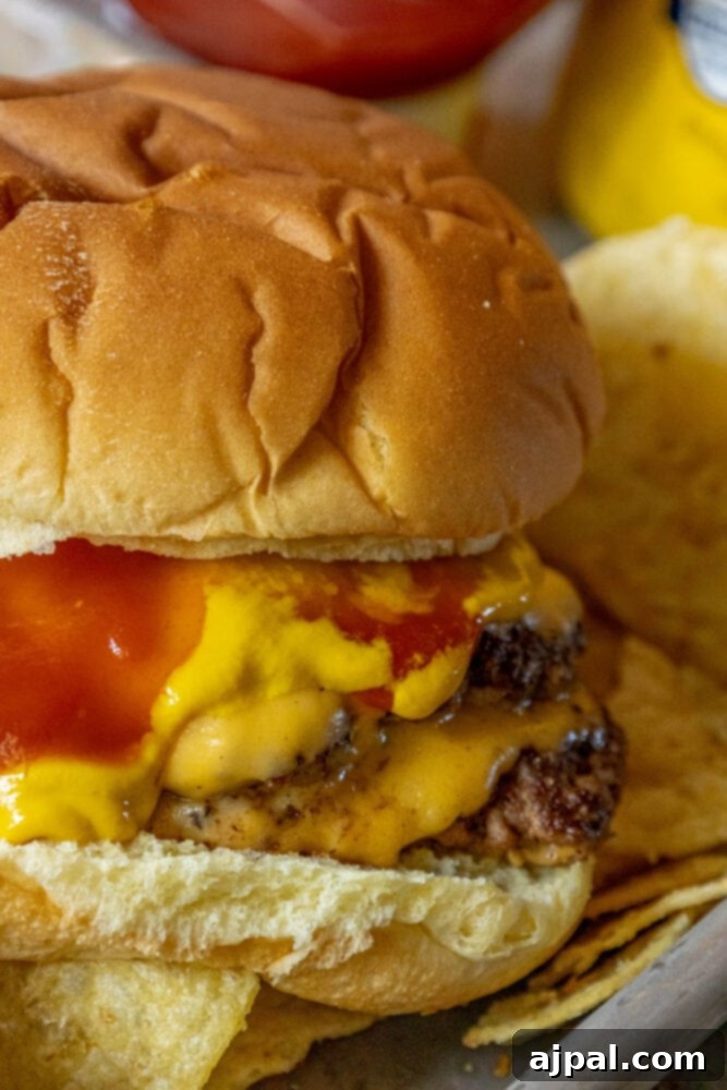 Smashburger in a bun on a metal plate