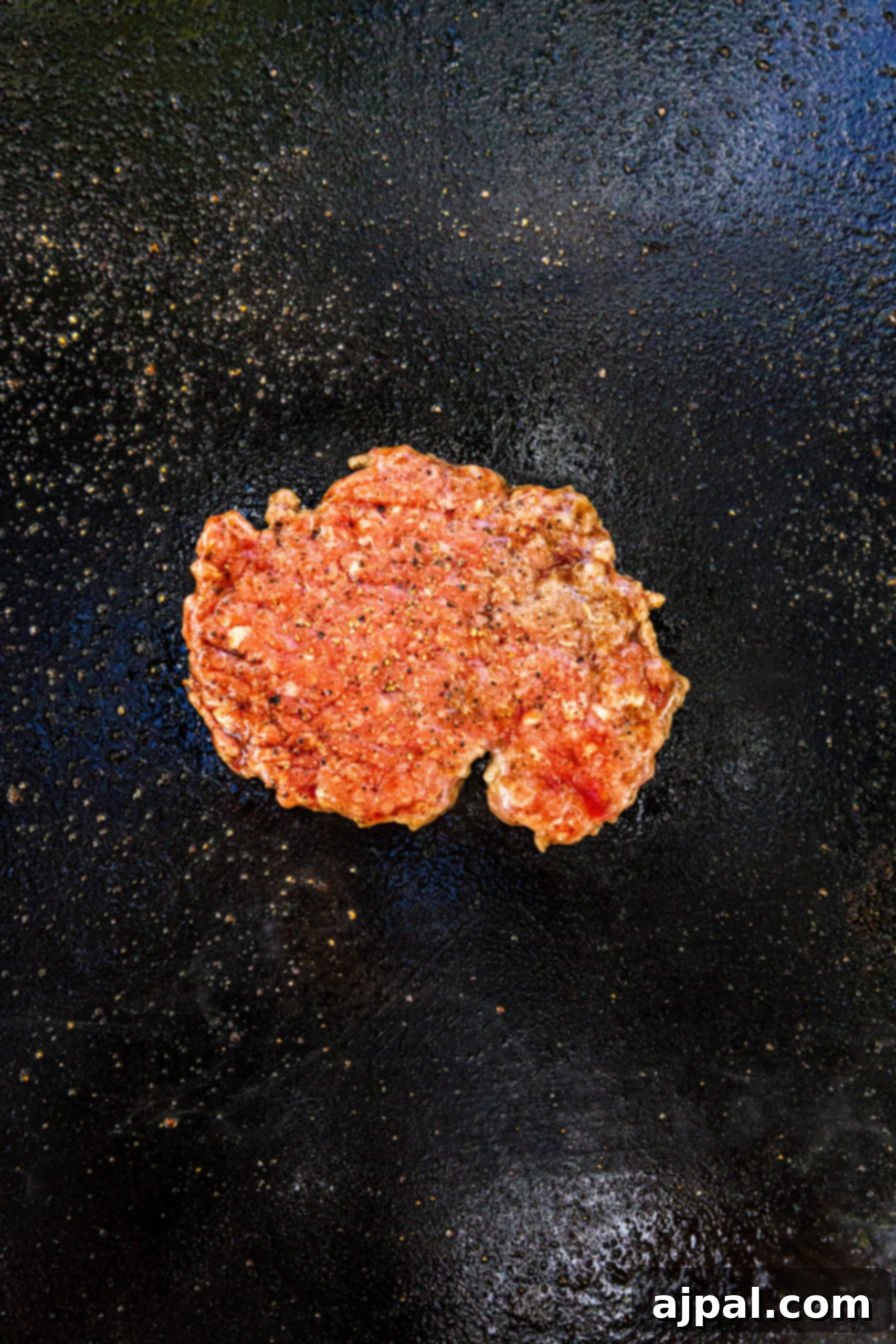 picture of smashed burger patty on a griddle
