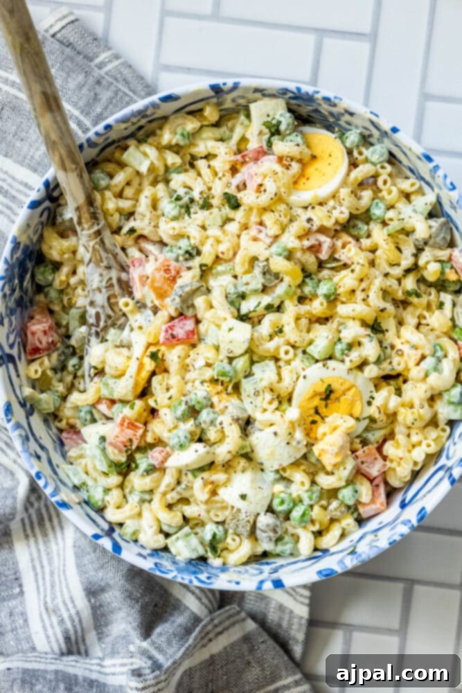 Close-up of classic macaroni salad with a generous amount of creamy dressing and finely diced vegetables
