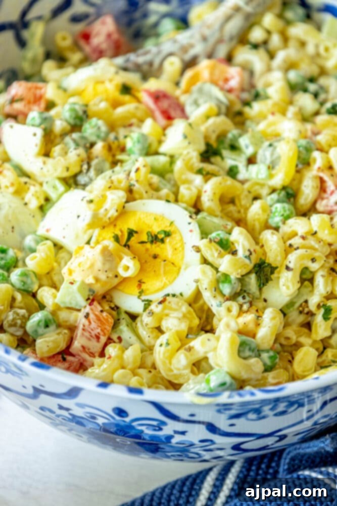 Overhead shot of a large bowl of homemade macaroni salad, showcasing its colorful ingredients and creamy texture