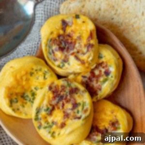 Instant Pot Egg Bites Recipe with bacon and cheese served on a wooden plate.
