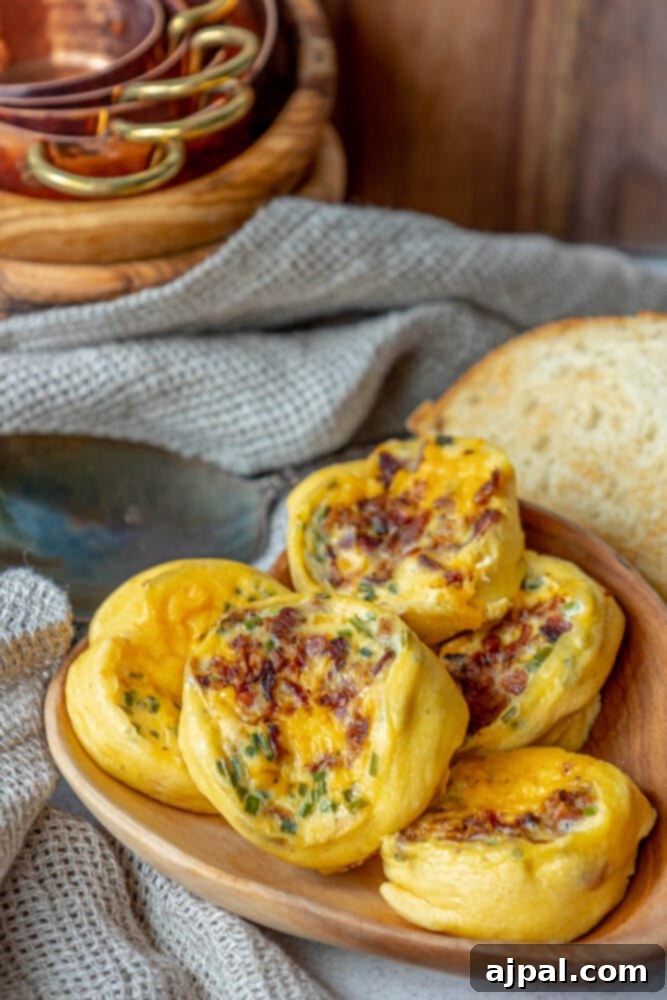 Fluffy Instant Pot Egg Bites 4 A mouth-watering close-up of savory Instant Pot egg bites, richly infused with crispy bacon and melted cheese, presented on an elegant wooden plate.