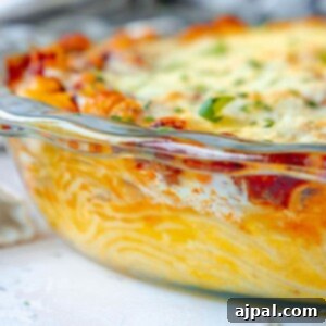 picture of baked spaghetti pie in a glass dish topped with cheese on a table