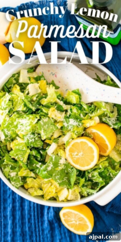 A refreshing and tangy lemon parmesan salad featuring crunchy lettuce and zesty lemon slices, presented in a stylish white bowl.