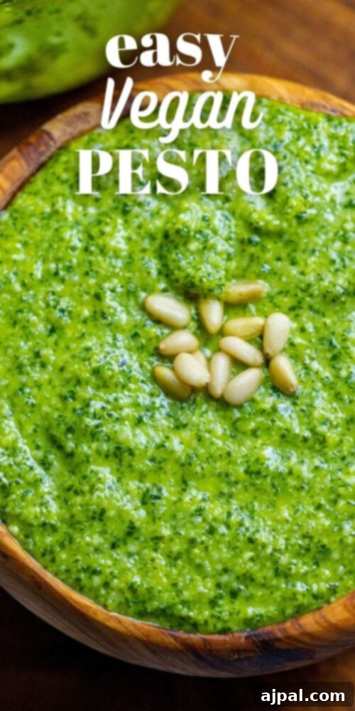 Effortless Vegan Pesto 6 A vertical shot of vibrant vegan pesto in a sleek wooden bowl, showcasing its smooth texture.