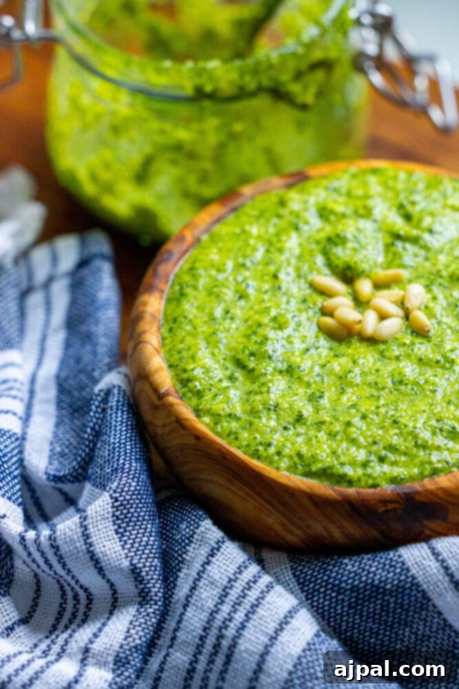 Effortless Vegan Pesto 5 A wooden bowl of easy vegan pesto sauce, invitingly placed on a table.