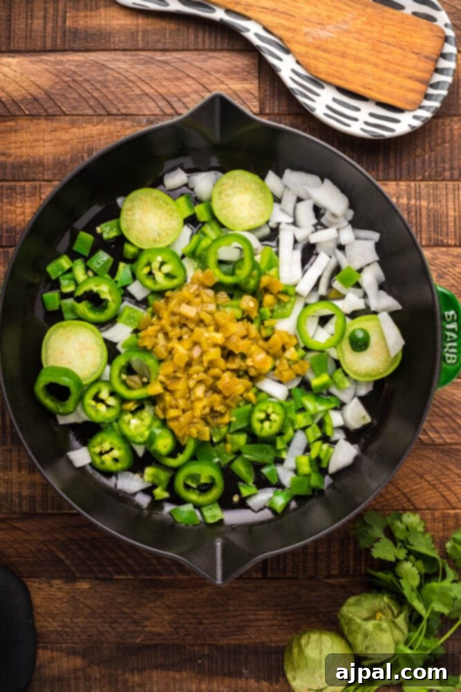 Chopped bell peppers and onions sizzling in a pan for the enchilada sauce base.