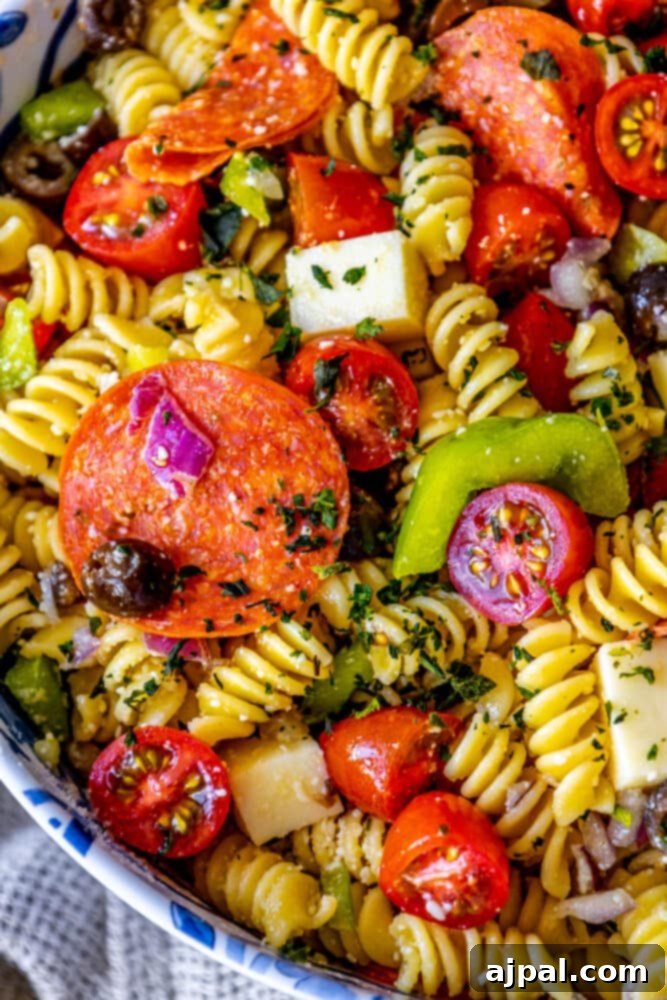 A delicious antipasti pasta salad with peppers and tomatoes.