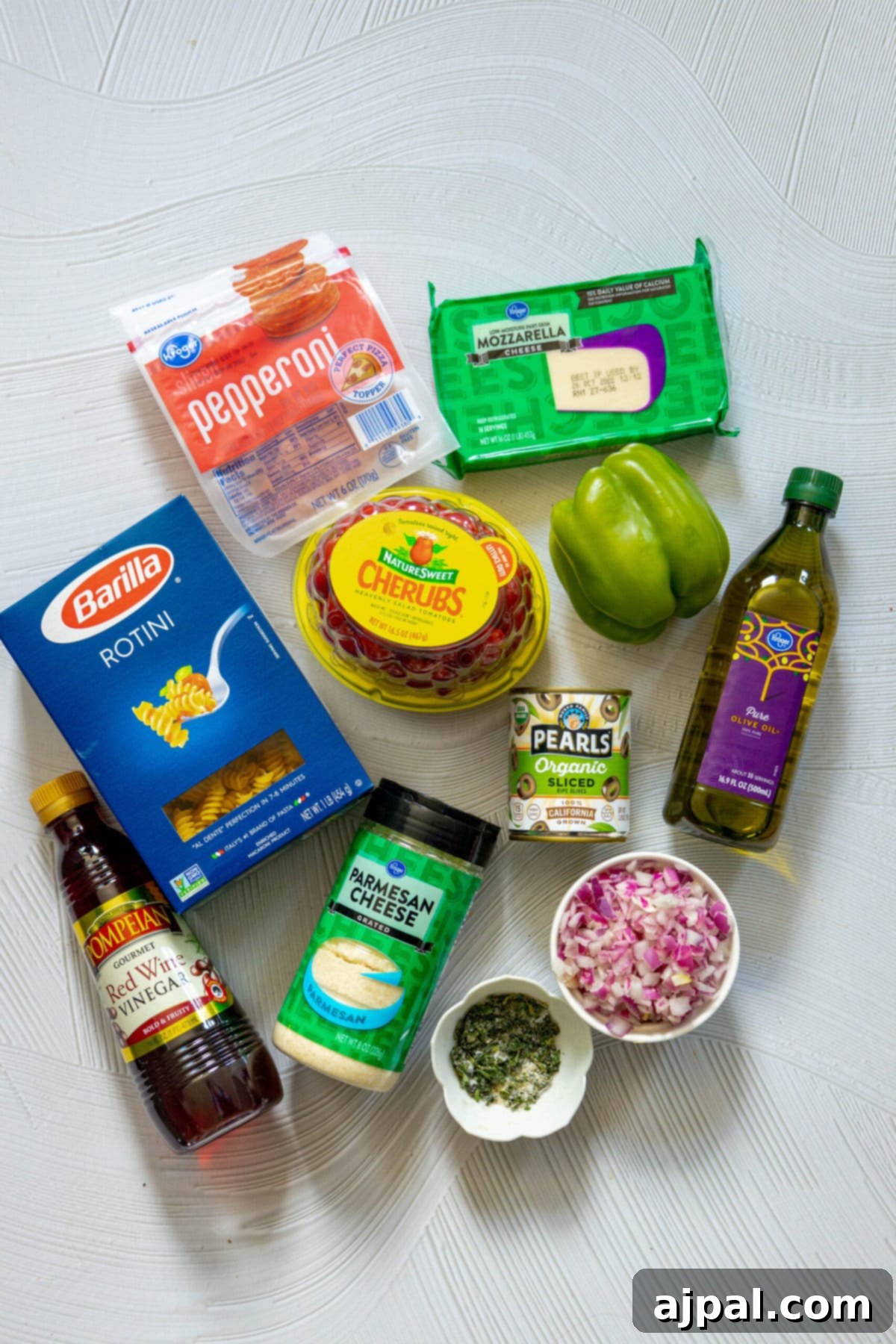 The ingredients for an Italian pizza are laid out on a table.