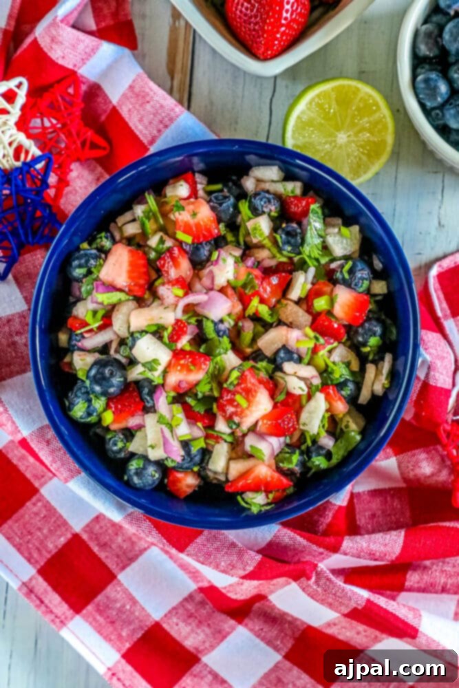 Red White Blue Fruit Salsa 9 A patriotic red, white, and blue fruit salsa served in a blue bowl, garnished beautifully.