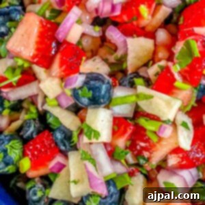 Red, white, and blue fruit salsa in a bowl, a refreshing 4th of July appetizer.