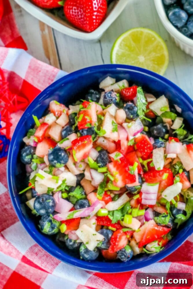 Red White Blue Fruit Salsa 4 A vibrant red, white, and blue fruit salsa in a blue bowl, ready to be served.