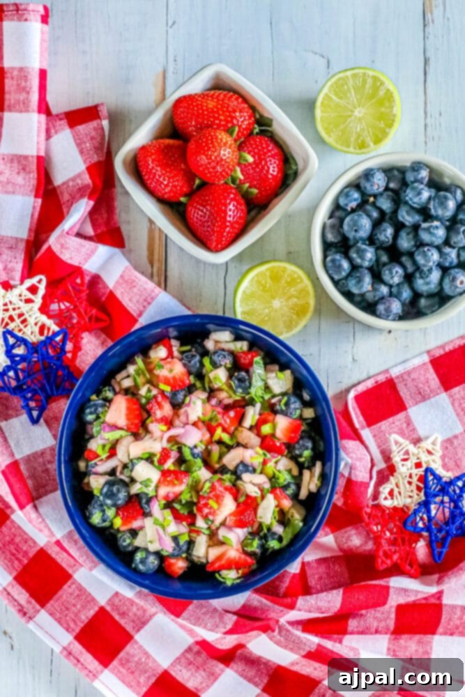 Red White Blue Fruit Salsa 7 A patriotic fruit salsa featuring blueberries, strawberries, and limes in a blue bowl, showcasing the vibrant colors.