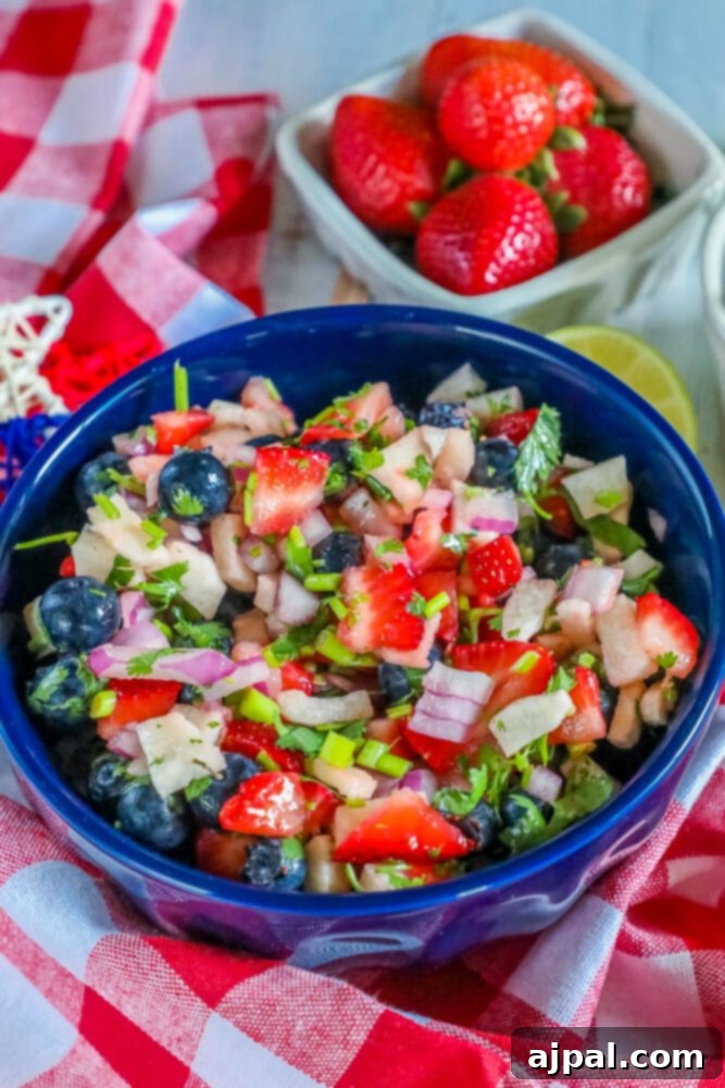 Red White Blue Fruit Salsa 8 A festive red and blue berry salad, perfect for 4th of July celebrations, in a blue bowl.
