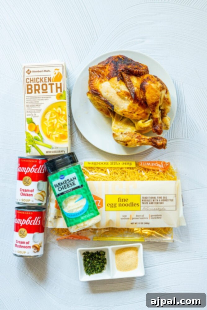 A colorful array of chicken tetrazzini ingredients laid out on a wooden table, including fresh vegetables, pasta, and various cheeses.