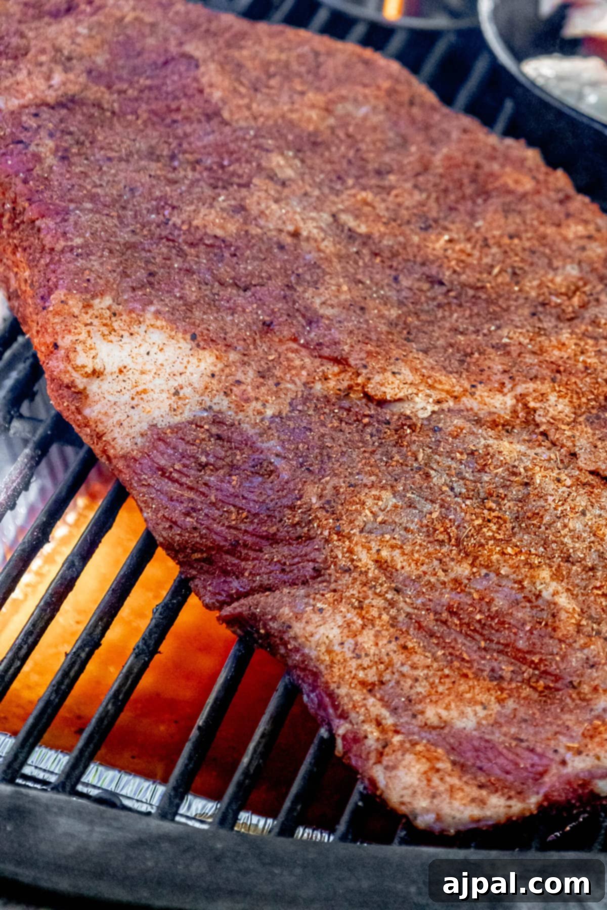 Hot and Fast Brisket Made Easy 5 a brisket cooking on a smoker grill with visible smoke