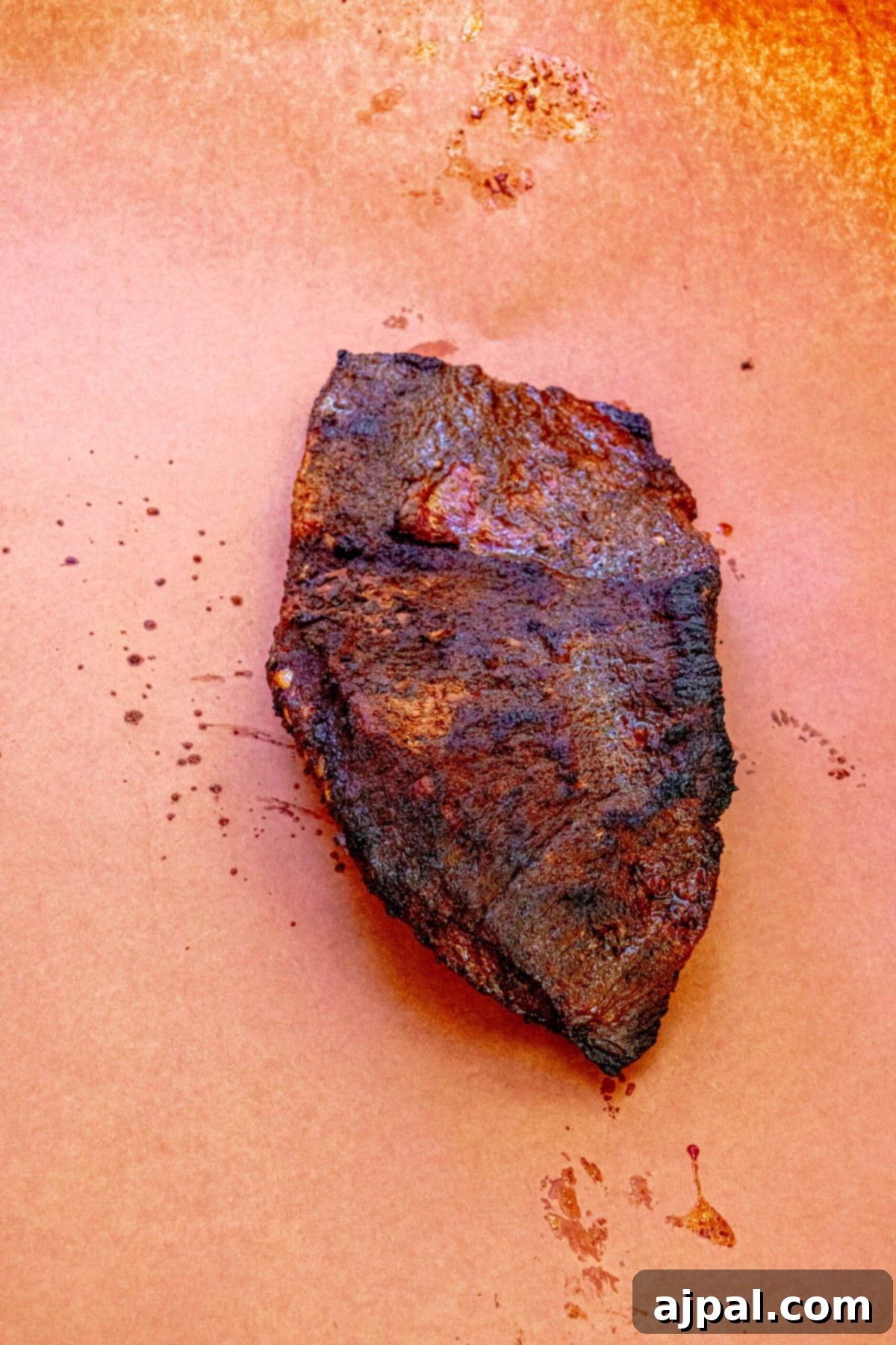 Hot and Fast Brisket Made Easy 6 a brisket on pink butcher paper, ready to be wrapped