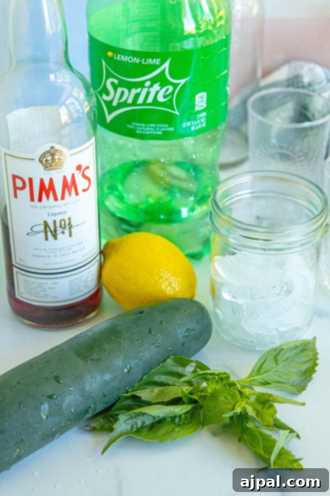 Various ingredients for Pimm's Cup cocktail, including cucumber, lemon-lime soda, Pimm's liqueur, fresh mint, and a whole lemon, neatly arranged on a table.
